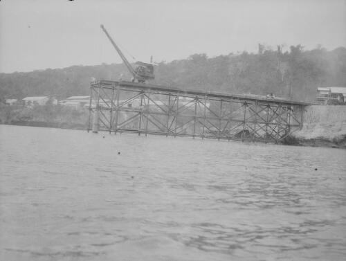 Workmen and crane during the construction of Christmas Island Phosphate Company pier, Christmas Island, approximately 1902, 12
