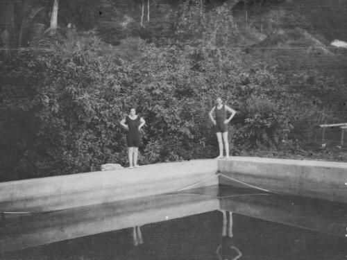 A man and a woman standing on the edge of a swimming pool, Christmas Island, approximately 1927