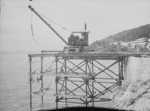 Workmen and crane during the construction of Christmas Island Phosphate Company pier, Christmas Island, approximately 1902, 18