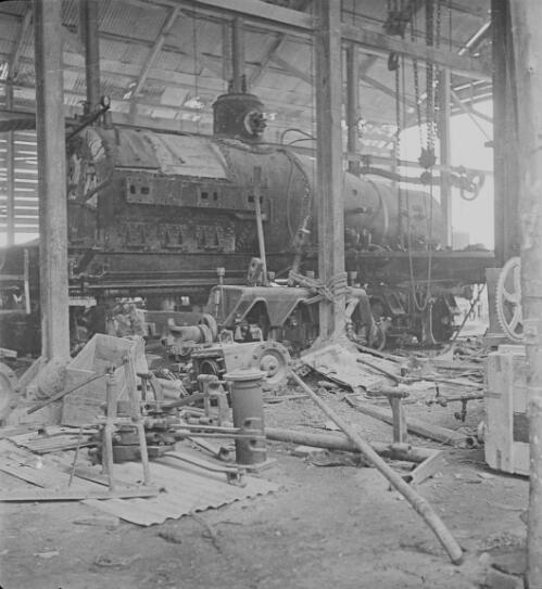 Parts of a disassembled steam locomotive on a flat wagon at a railway workshop, approximately 1920, 3
