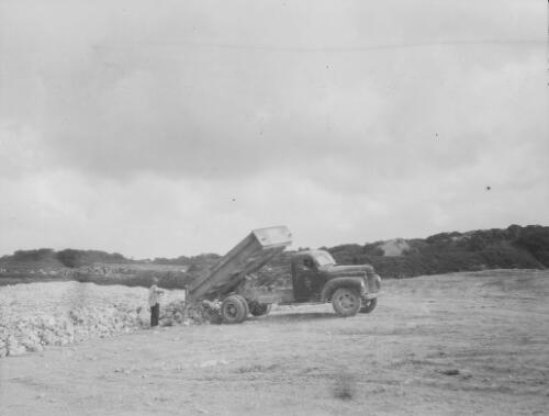 A Christmas Island Phosphate Company tipper truck unloading rocks at the phosphate mine, Christmas Island, approximately 1927