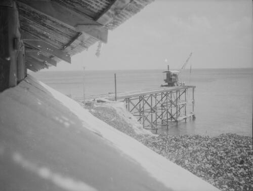 Workmen and crane during the construction of Christmas Island Phosphate Company pier, Christmas Island, approximately 1927, 4