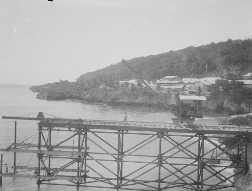 Workmen and crane during the construction of Christmas Island Phosphate Company pier, Christmas Island, approximately 1927, 6