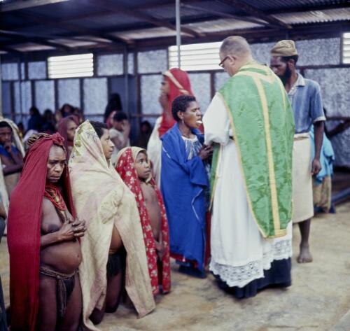 Bishop Bernarding giving communion to parishioners at Pipirpena near Mount Hagen, Papua New Guinea, approximately 1968 / Robin Smith