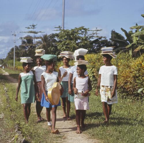 School girls carrying their books on their heads, Madang Province, Papua New Guinea, approximately 1968 / Robin Smith
