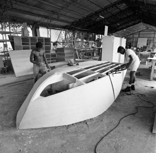 Two men constructing a boat at Briggs MacLean, Madang Province, Papua New Guinea, approximately 1968 / Robin Smith