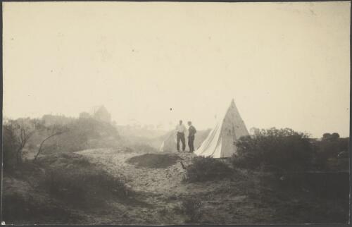 Two explorers standing beside a tent pitched at magnetic station, Port Augusta, South Australia, August 1914 / Alexander Lorimer Kennedy