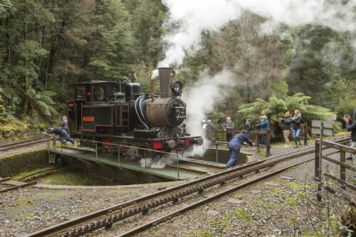 West Coast Wilderness Railway stoker Kara Barker and train driver Tony Rinaudo turning around the Mount Lyell No. 3 Abt class steam locomotive at the railway turntable with tourists watching on at Dubbil Barril railway station, Tasmania, 10 August 2019 / Greg Power