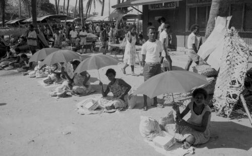 Women sitting under umbrellas selling betel nuts and limes, Koki Market, Port Moresby, Papua New Guinea, approximately 1968 / Robin Smith