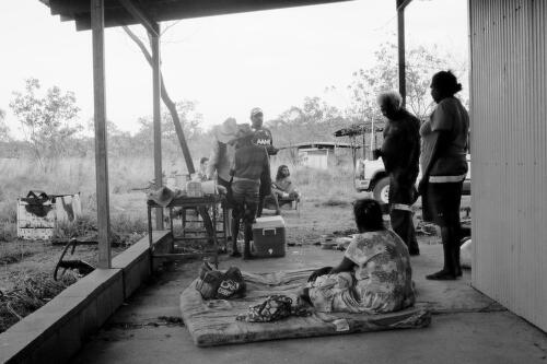 Eight people gathered beside a dwelling, Gulf of Carpentaria, Australia, 2014 / Hamish Cairns