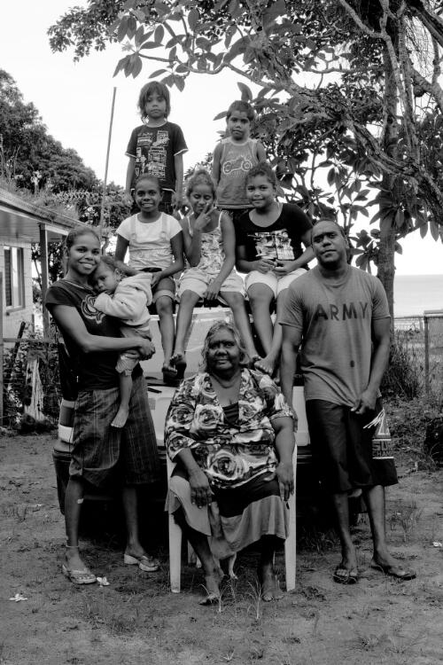 A group of Aboriginal Australians outside a house, Palm Island, Queensland, 21 November 2010 / Hamish Cairns