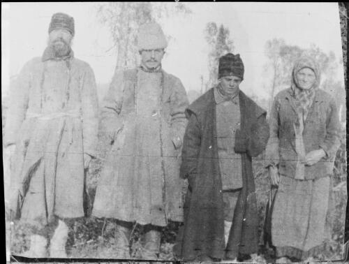 Group of four people dressed in coats and hats, Russia, 1917 / Michael Terry
