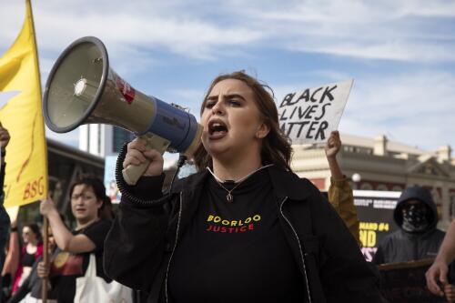 Protester Tanesha Bennell holding a megaphone at the Black Lives Matter protest rally, Perth, Western Australia, 2020 / Philip Gostelow