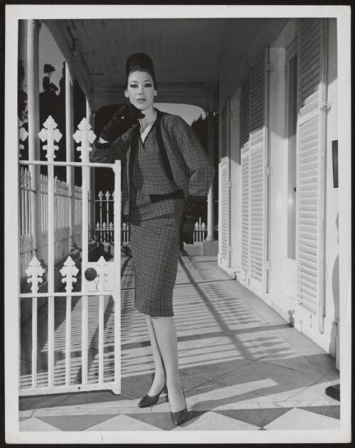 Diane Masters wearing a tweed skirt and jacket, approximately 1960, 2 / Athol Shmith