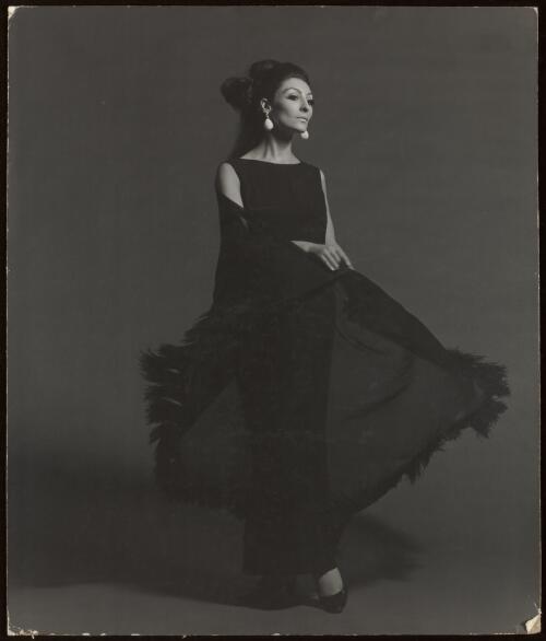 Fashion model in black dress and fringed stole, approximately 1968, 1 / Athol Shmith