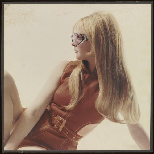 Long haired blonde model wearing sunglasses for Pru Acton Cosmetics, approximately 1969 / Athol Shmith