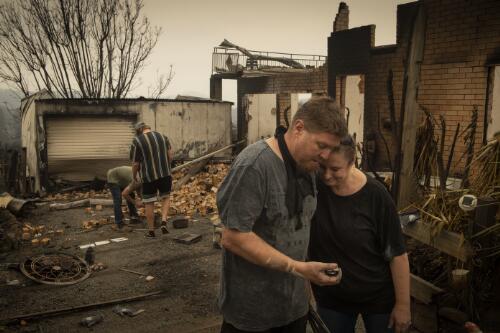 Michael Fletcher and Maree Fletcher inspecting their property destroyed by the Currowan bushfire, Conjola Park, New South Wales, 5 January, 2020 / Matthew Abbott