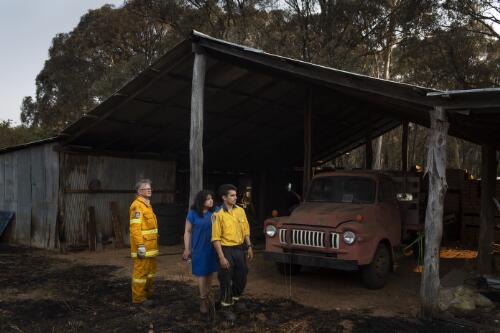 Volunteer firefighters Michael Blenkins, Edmund Blenkins and his mother Sulari Gentill assessing the shed on their property damaged by the Currowan bushfires, near Batlow, New South Wales, 9 January, 2020 / Matthew Abbott