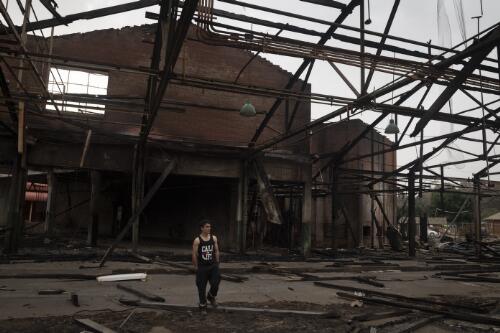 Volunteer fire fighter Edmund Blenkins standing in the old Batlow cannery that was destroyed during the bushfires, Batlow, New South Wales, 10 January, 2020 / Matthew Abbott