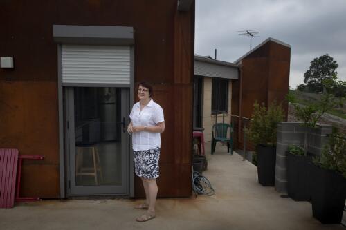 Susan Templeman standing in front of her new bushfire resistant house, Winmalee, Blue Mountains, New South Wales, 28 January, 2020 / Matthew Abbott