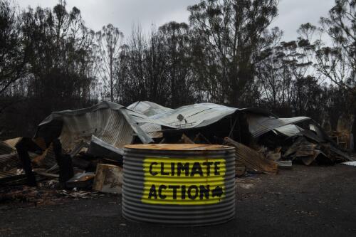 A sign painted on destroyed property calling for climate action, Yatte Yattah, New South Wales, 16 February 2020 / Matthew Abbott