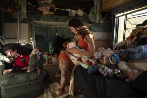 A mother with her new born baby during the COVID-19 pandemic, living in a donated caravan after their rented house was destroyed during the bushfire crisis, Cobargo, New South Wales, 5 May 2020 / Matthew Abbott