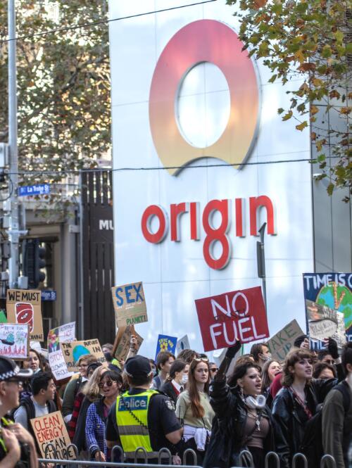 Protesters holding placards marching past the Origin Energy offices, during the School Strike 4 Climate rally, Melbourne, 21 May 2021 / Leigh Henningham