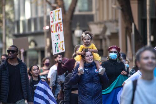 Protesters holding placards marching through the city streets during the School Strike 4 Climate rally, Melbourne, 21 May 2021, 2 / Leigh Henningham