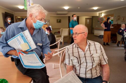 Director of nursing, Paul Hilder explaining to resident Bob the requirements of the consent form for the COVID-19 vaccine, at the Trentham Aged Care Facility,Victoria, March 2021 / Sandy Scheltema