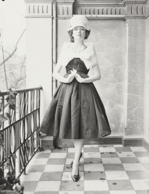 A model in a dress and hat standing on balcony, approximately 1965, 1 / Athol Shmith