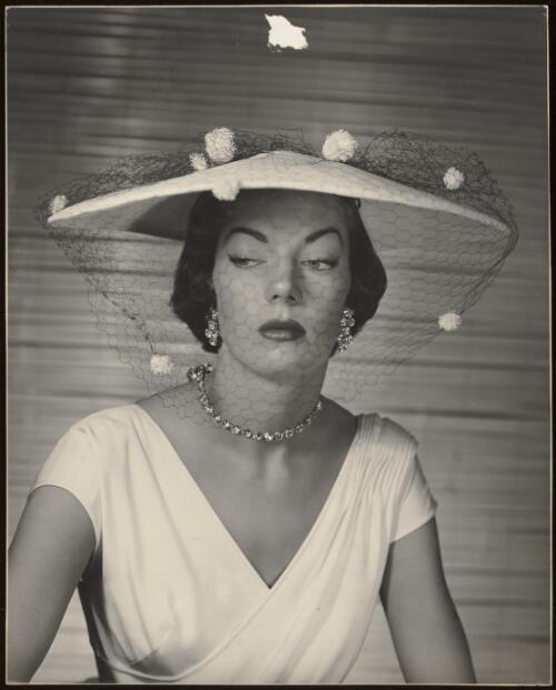 Model in dress and hat with veil, approximately 1955 / Athol Shmith