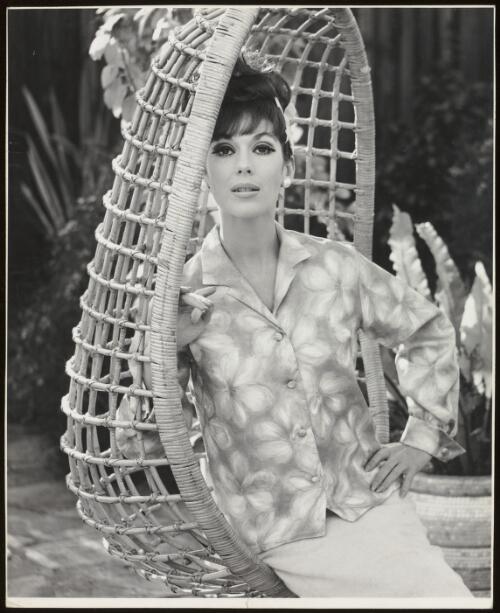 Anne Hamilton sitting in a suspended chair, approximately 1965 / Athol Shmith