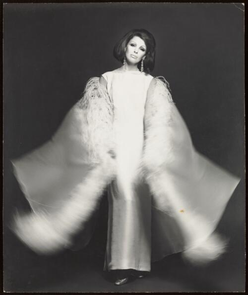 Model Georgie Gold wearing an evening gown, approximately 1966 / Athol Shmith