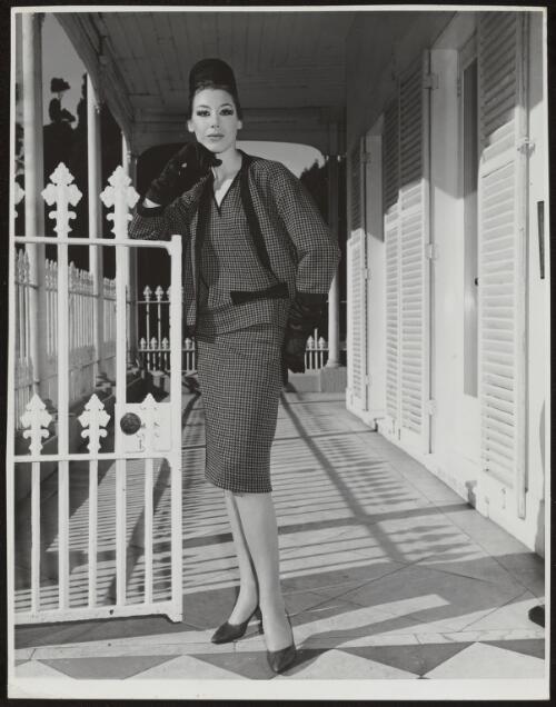Diane Masters wearing a tweed skirt and jacket, approximately 1960, 1 / Athol Shmith