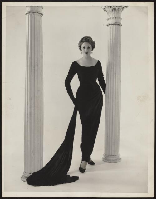 Model wearing slinky evening dress holding stole, approximately 1965 / Athol Shmith