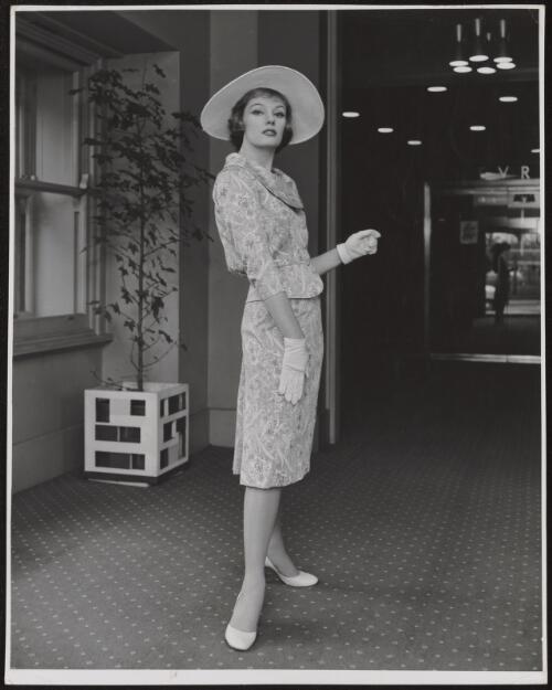 Model wearing a suit and hat, approximately 1956 / Athol Shmith