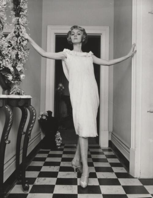 Fashion model posing in a hallway, approximately 1968, 2 / Athol Shmith