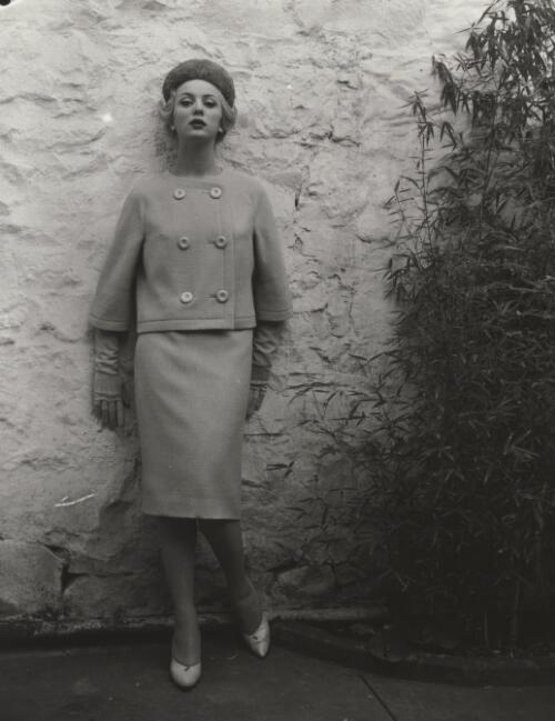 Fashion model posing against wall, approximately 1968, 3 / Athol Shmith