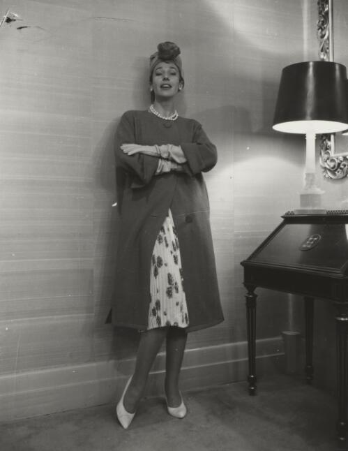 Fashion model posing beside a lamp, approximately 1968, 1 / Athol Shmith
