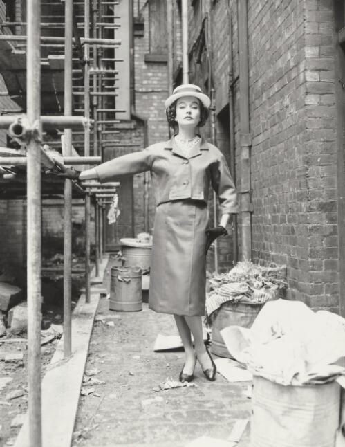 Fashion model posing in a back alley, approximately 1968, 2 / Athol Shmith