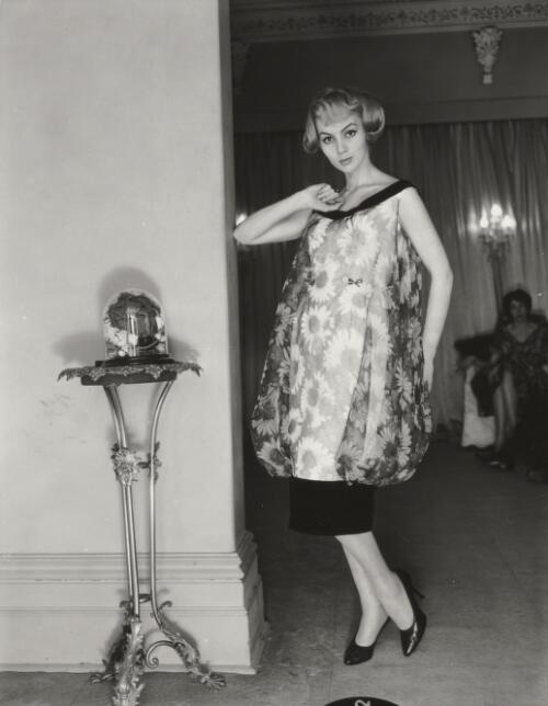 Fashion model standing near living room, approximately 1968 / Athol Shmith