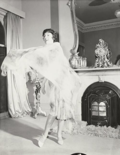 Fashion model posing beside a mantle piece, approximately 1968, 4 / Athol Shmith
