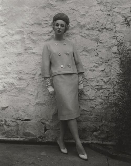 Fashion model posing against wall, approximately 1968, 4 / Athol Shmith