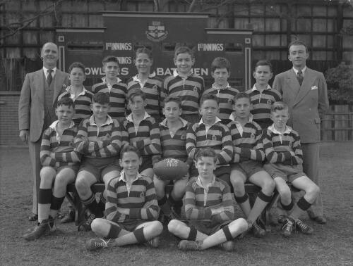 Group portrait of Sydney Grammar School pupils' rugby team 'the Bees' 13B and their coaches, Sydney, 9 August 1950
