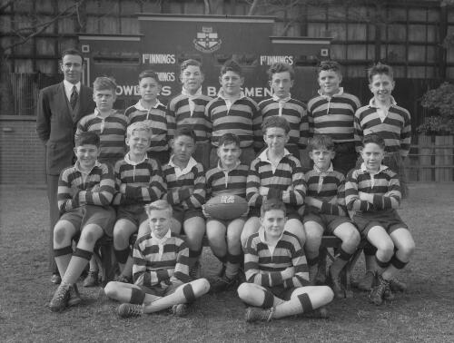 Group portrait of Sydney Grammar School pupils' rugby team 13D and their coach, Sydney, 9 August 1950