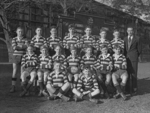 Group portrait of Sydney Grammar School pupils' rugby team 14B and their coach, Sydney, 9 August 1950