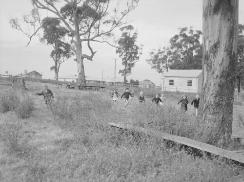Group of school children from Sandgate Infants School playing outside, Sandgate, New South Wales, 1949
