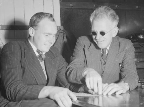 William Davis from the Newcastle branch of the Royal Sydney Blind Institution teaching braille to Frank Newman of Charlotte Bay near Forster, New South Wales, 1949