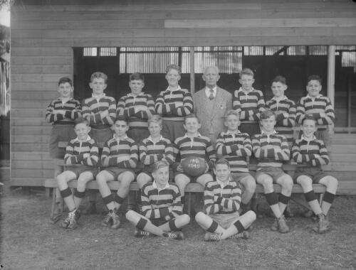 Group portrait of Sydney Grammar School pupils' rugby team 14C and coach, Sydney, 8 August 1949
