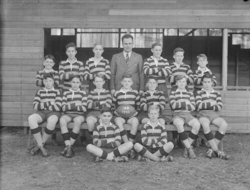 Group portrait of Sydney Grammar School pupils' rugby team 14B and coach, Sydney, 8 August 1949